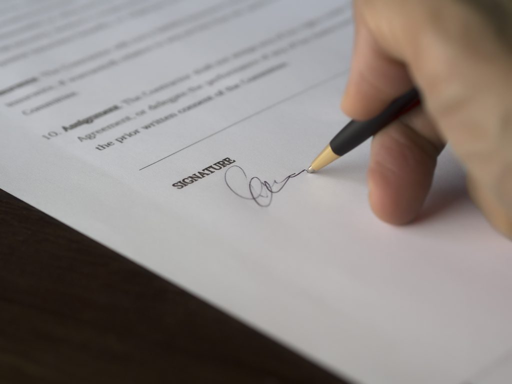 Someone signing a document
