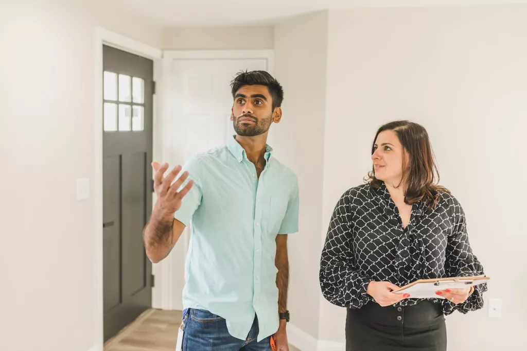 A man and a woman in the hallway of a house