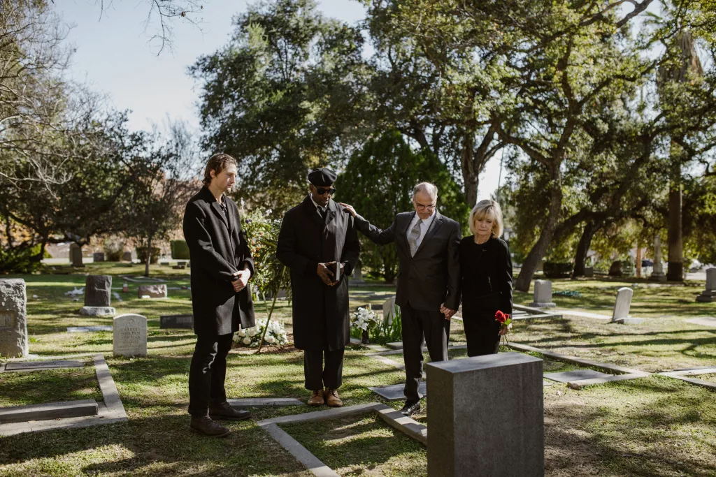 mourners gathered at a graveside